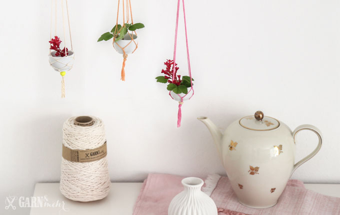 Stillleben mit Vintage Teekann und Garnkone mit 3 hängenden Mini-Vasenn aus Porzellanschalen mit rosa Garn und Makramee